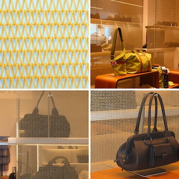 Close-up detail of BZ-1010 spiral woven metal mesh in vibrant yellow-gold finish, showing interlocking spiral weave pattern used as decorative screen in a modern shopping mall