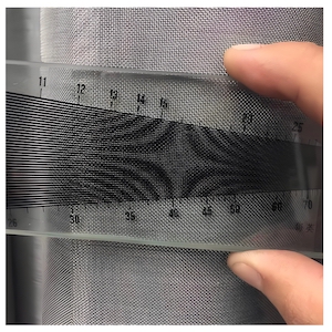 Measuring 40 mesh stainless steel wire mesh density with a mesh counter for quality control.